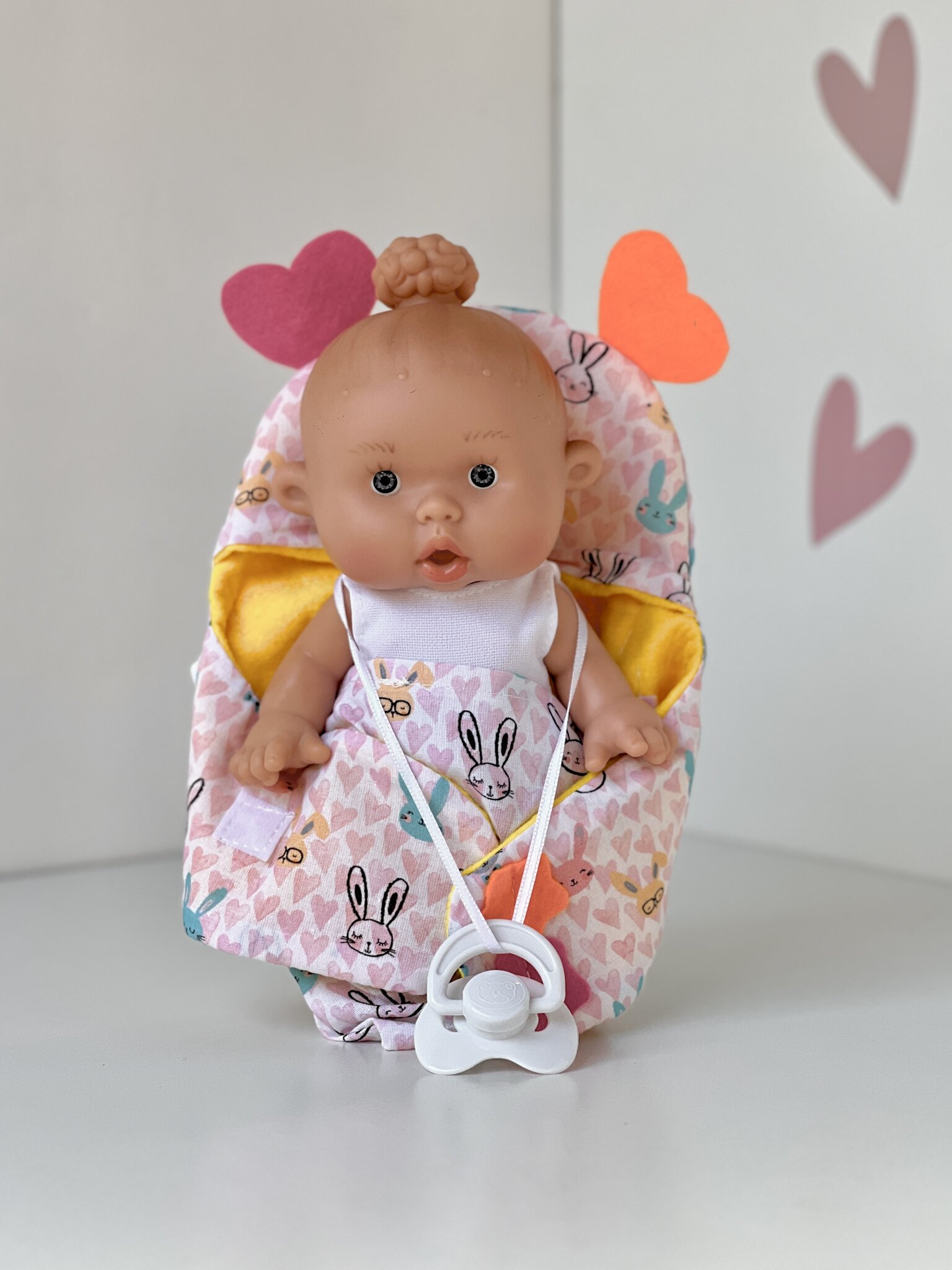 Scented doll, girl, with a bun, in a carrier (rabbits), 21 cm (Marina&Pau)